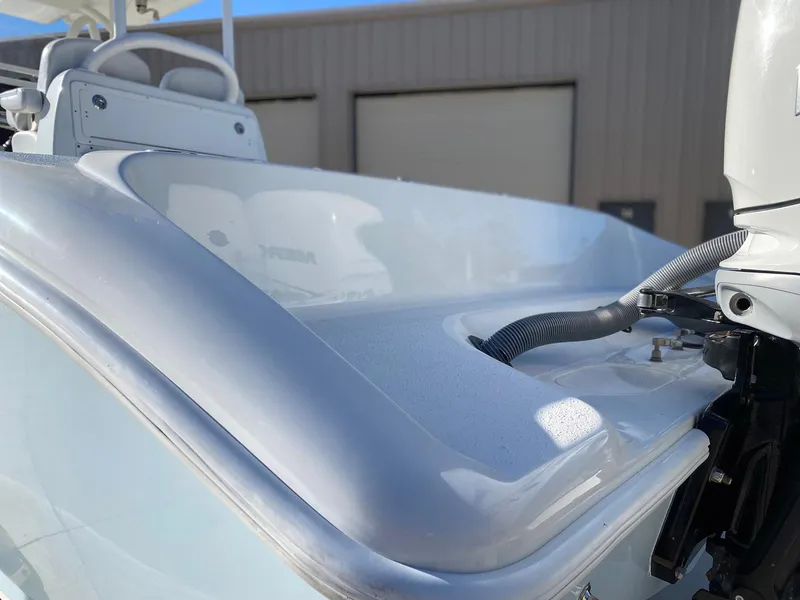 Slide: The Image of 2019 Yellowfin 29 Offshore boat detail with engine and seating area. - 2