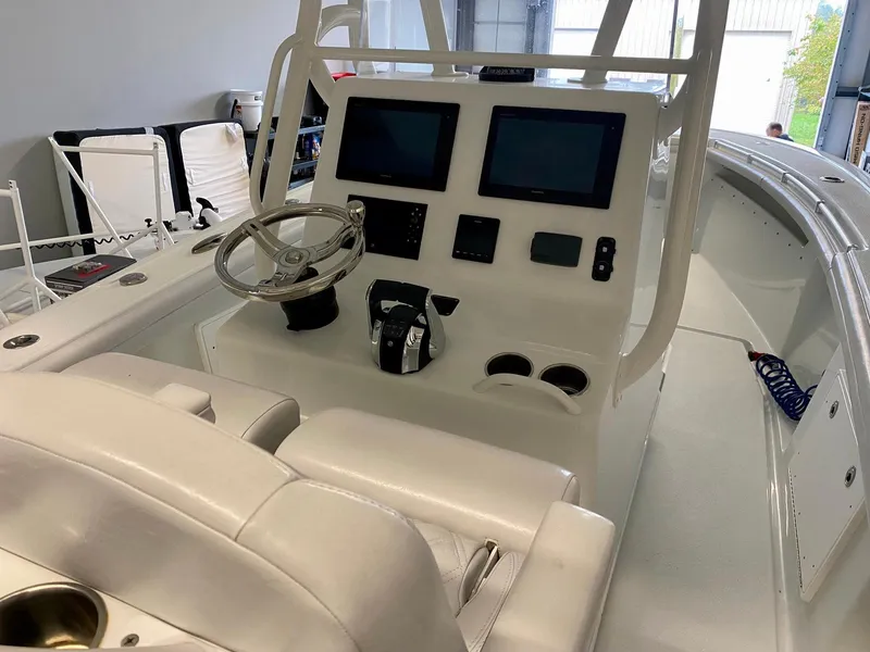Slide: The Image of 2019 Yellowfin 29 Offshore boat cockpit with dual screens and steering wheel. - 25
