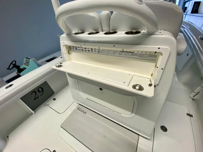 Slide: The Image of 2019 Yellowfin 29 Offshore boat interior with storage compartment and seating. - 26