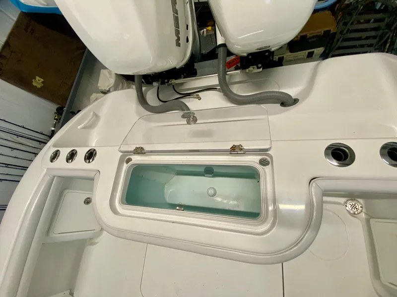 Slide: The Image of 2019 Yellowfin 29 Offshore boat deck with livewell and dual engines. - 27