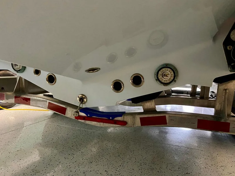 Slide: The Image of 2019 Yellowfin 29 Offshore boat hull on trailer, showcasing drainage and fittings. - 28