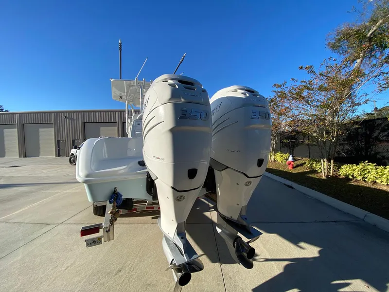 Slide: The Image of 2019 Yellowfin 29 Offshore boat with dual outboard motors in a sunny outdoor setting. - 5