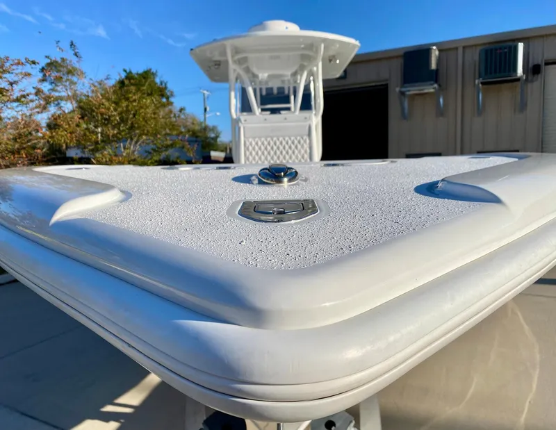 Slide: The Image of 2019 Yellowfin 29 Offshore boat, close-up of bow, sleek design, outdoor setting. - 6