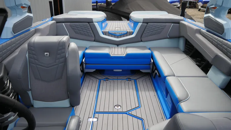Slide: The Image of 2023 Nautique Super Air G23 interior with blue and gray seating and sleek design. - 14