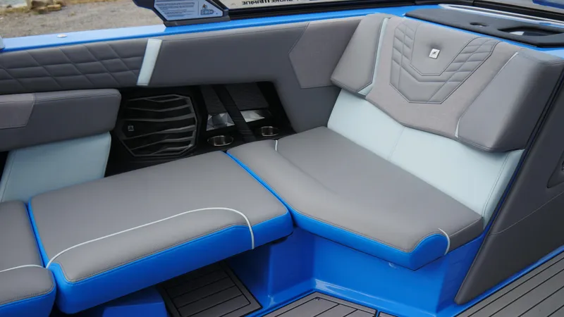 Slide: The Image of 2023 Nautique Super Air G23 interior with blue and gray seating, featuring modern design. - 8