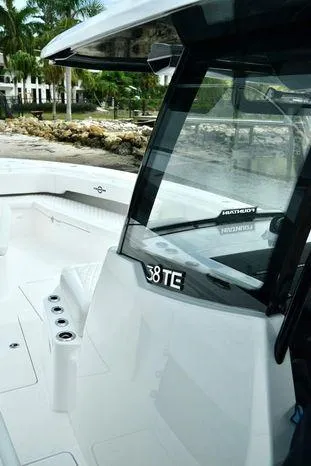 Slide: The Image of 2024 Fountain Bluewater 38 Tournament Edition boat, sleek design, docked near palm trees. - 18