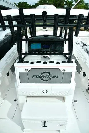 Slide: The Image of 2024 Fountain Bluewater 38 Tournament Edition boat interior with rod holders and control panel. - 8