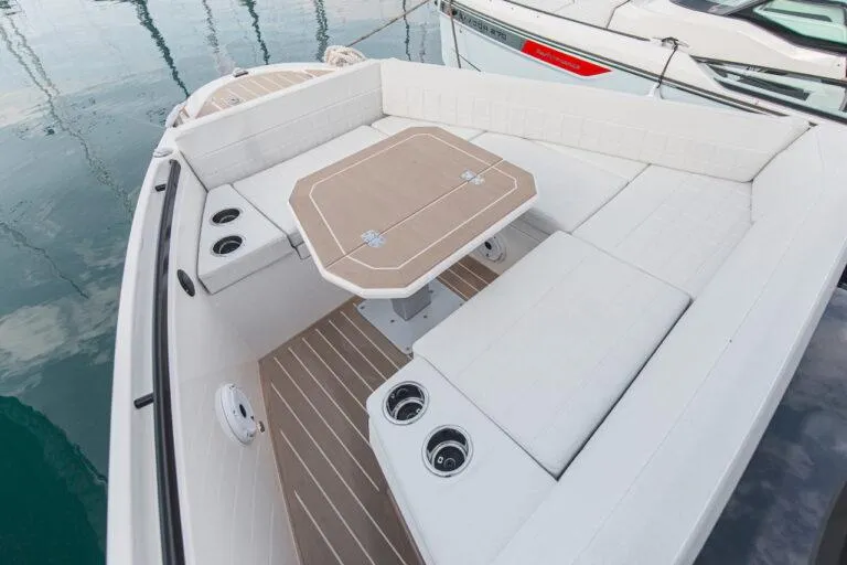 Slide: The Image of 2025 Saxdor 340 GTWA boat interior with modern helm and seating, cruising on scenic waters. - 16