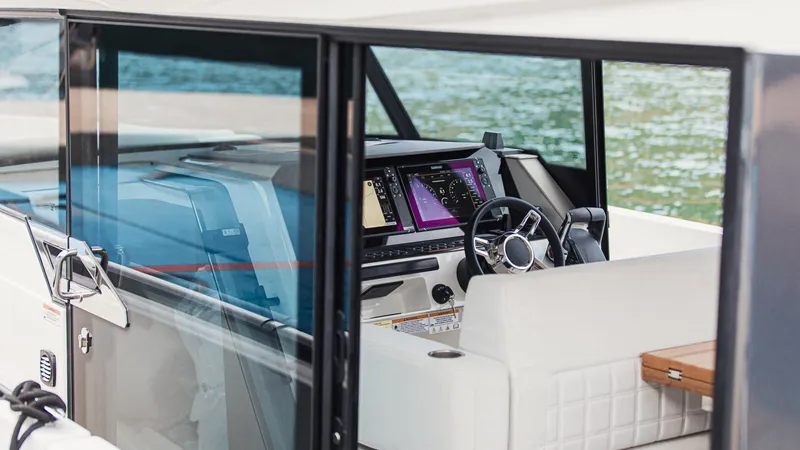 Slide: The Image of Luxurious seating area on 2026 Saxdor 340 GTWA boat with wooden table and cup holders. - 19