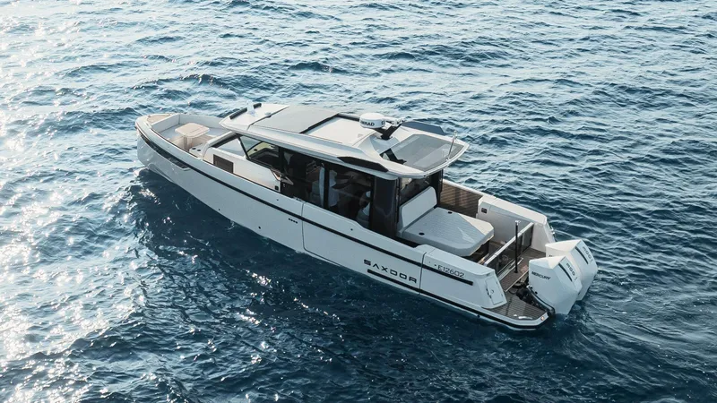 Slide: The Image of 2026 Saxdor 340 GTWA boat with twin Mercury engines docked at marina. - 4