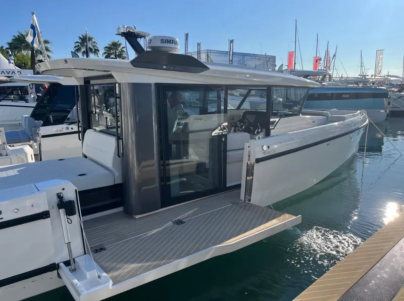 Slide: The Image of 2025 Saxdor 340 GTWA boat docked at sunset, showcasing sleek design and modern features. - 9