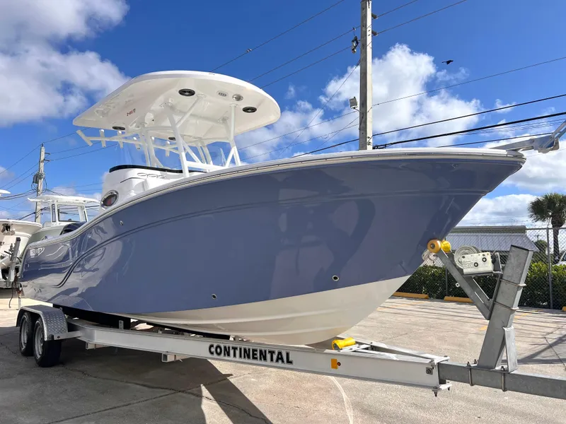 Slide: The Image of 2025 Sea Fox 248 Side Console boat on a Continental trailer, under a clear blue sky. - 10