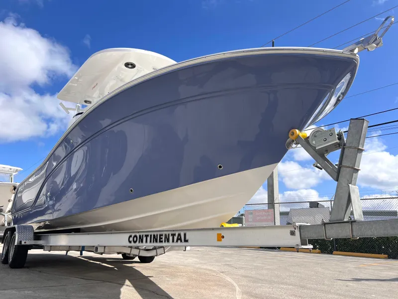 Slide: The Image of 2025 Sea Fox 248 Side Console boat on trailer under blue sky. - 11