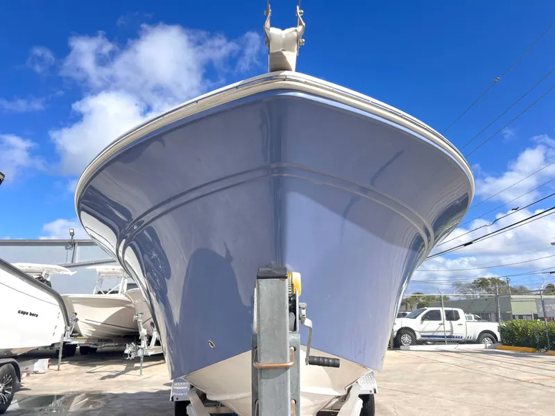 Slide: The Image of 2025 Sea Fox 248 Side Console boat, front view, parked outdoors under blue sky. - 12
