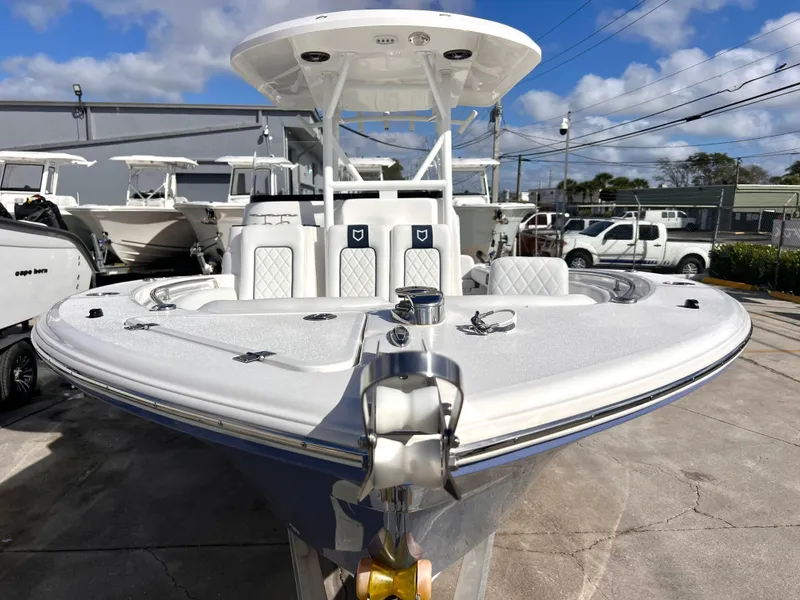 Slide: The Image of 2025 Sea Fox 248 Side Console boat, docked, showcasing sleek design and spacious seating. - 13