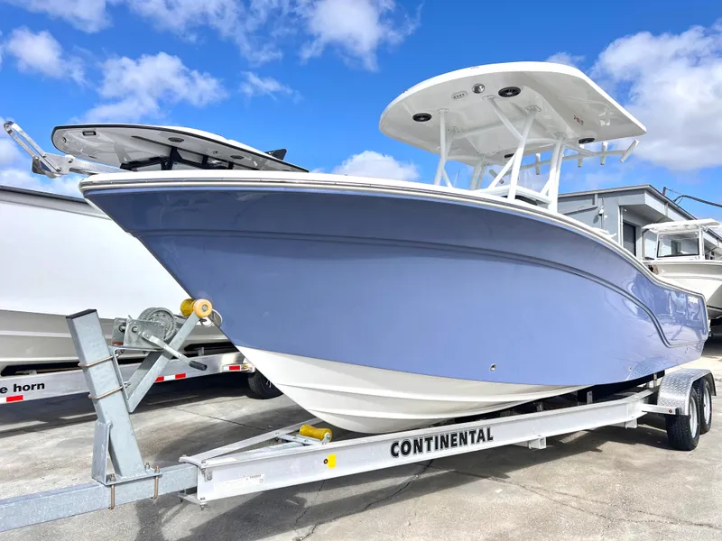 Slide: The Image of 2025 Sea Fox 248 Side Console boat on trailer, under clear blue sky. - 17