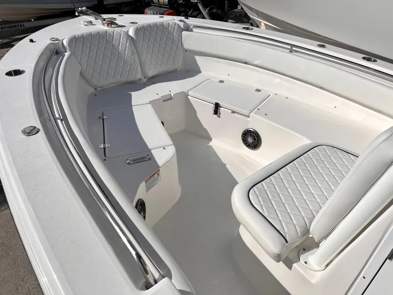 Slide: The Image of 2025 Sea Fox 248 Side Console boat interior with white cushioned seating. - 18