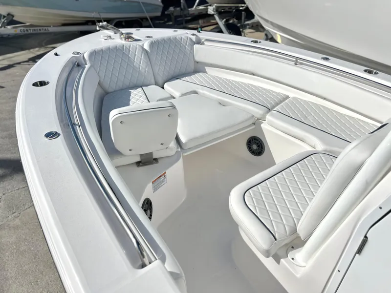 Slide: The Image of 2025 Sea Fox 248 Side Console boat interior with white cushioned seating. - 21