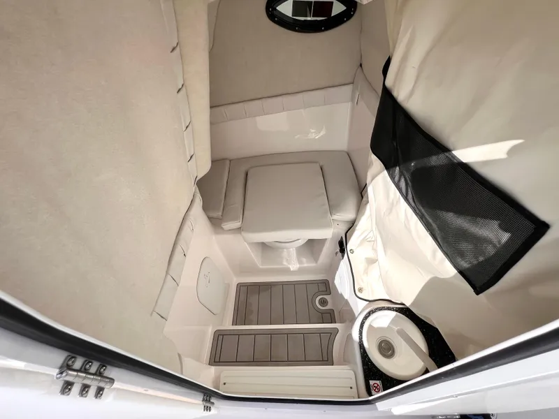 Slide: The Image of 2025 Sea Fox 248 Side Console interior cabin with seating and storage. - 27