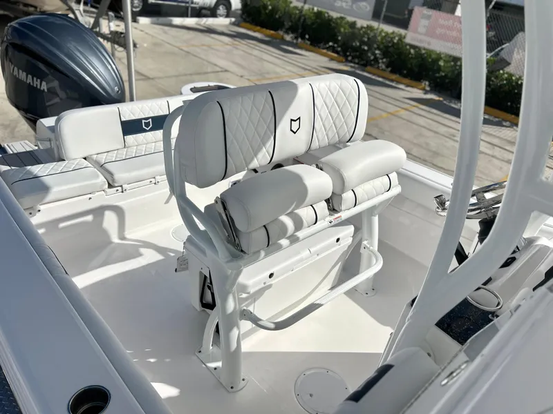 Slide: The Image of 2025 Sea Fox 248 Side Console boat interior with white cushioned seating. - 31