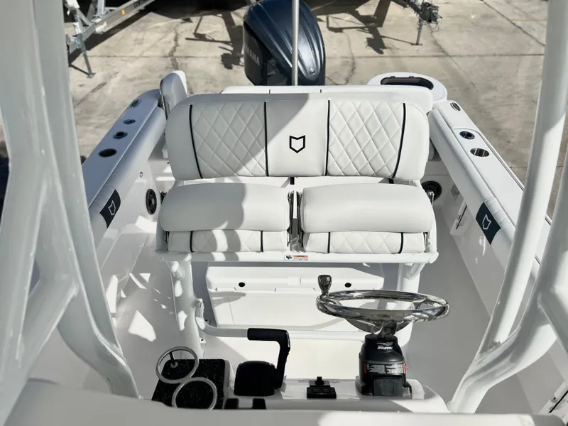 Slide: The Image of 2025 Sea Fox 248 Side Console boat interior with white seating and steering wheel. - 32