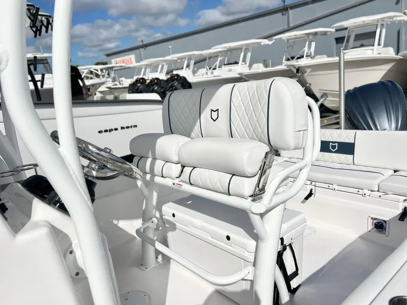 Slide: The Image of 2025 Sea Fox 248 Side Console boat interior with white seating and steering wheel. - 33