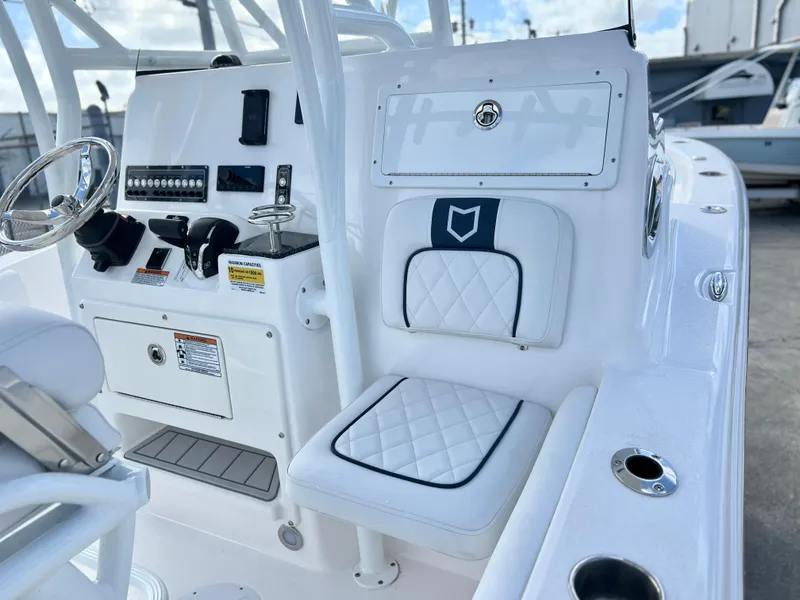 Slide: The Image of 2025 Sea Fox 248 Side Console boat interior with white seating and control panel. - 39
