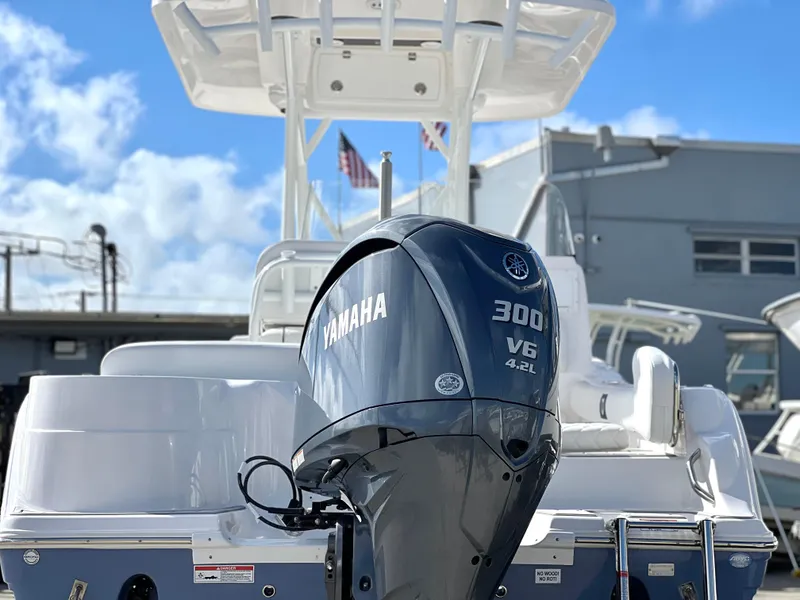 Slide: The Image of 2025 Sea Fox 248 Side Console boat with Yamaha 300 V6 engine, docked under blue sky. - 6