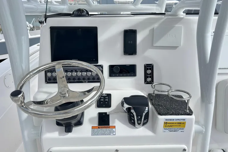 Slide: The Image of 2025 Sea Fox 248 Side Console dashboard with steering wheel, controls, and cup holders. - 64