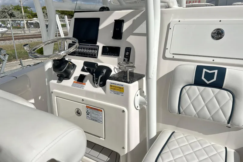 Slide: The Image of 2025 Sea Fox 248 Side Console boat interior with steering wheel and control panel. - 65