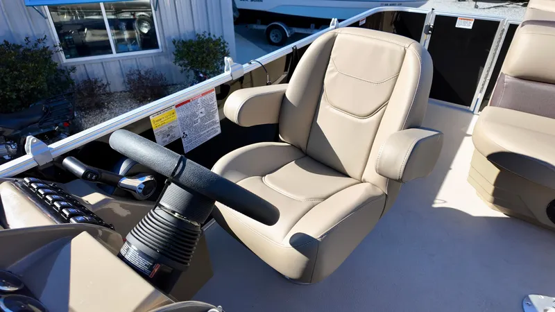 Slide: The Image of Captain's chair on 2025 Sylvan Mirage 820 CRS boat, featuring beige upholstery and steering wheel. - 10