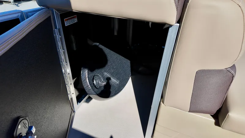 Slide: The Image of 2025 Sylvan Mirage 820 CRS interior storage compartment with open door. - 12