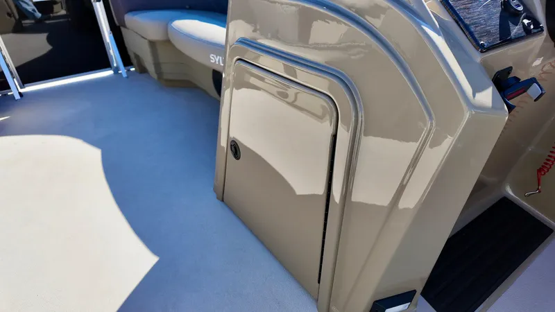 Slide: The Image of 2025 Sylvan Mirage 820 CRS interior, featuring sleek beige cabinetry and seating. - 13