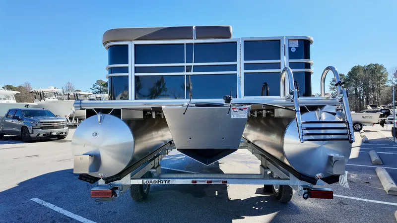 Slide: The Image of 2025 Sylvan Mirage 820 CRS pontoon boat on trailer in parking lot. - 2