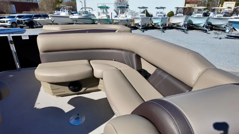 Slide: The Image of 2025 Sylvan Mirage 820 CRS boat interior with beige and brown seating. - 6