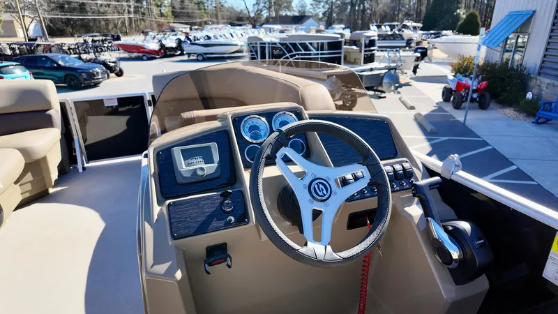Slide: The Image of 2025 Sylvan Mirage 820 CRS boat dashboard with steering wheel and controls. - 7