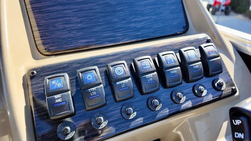 Slide: The Image of Control panel of 2025 Sylvan Mirage 820 CRS boat with labeled switches. - 9