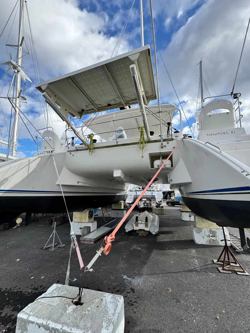 Slide: The Image of 2003 Catana 431 catamaran on dry dock, Newport, RI, with solar panels and clear sky. - 10