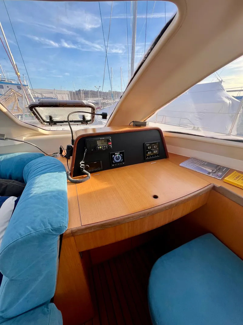 Slide: The Image of Interior of 2003 Catana 431 yacht with navigation equipment and blue seating. - 18