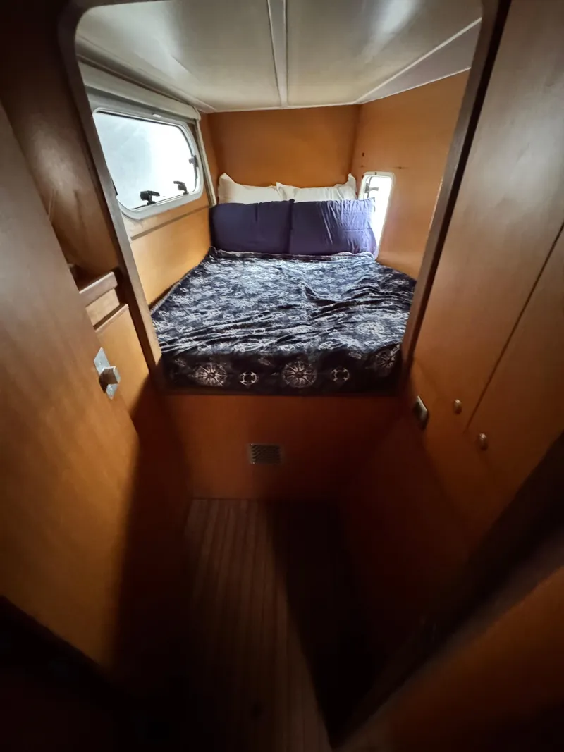 Slide: The Image of Cozy cabin interior of 2003 Catana 431 with a comfortable bed and wooden finish. - 20