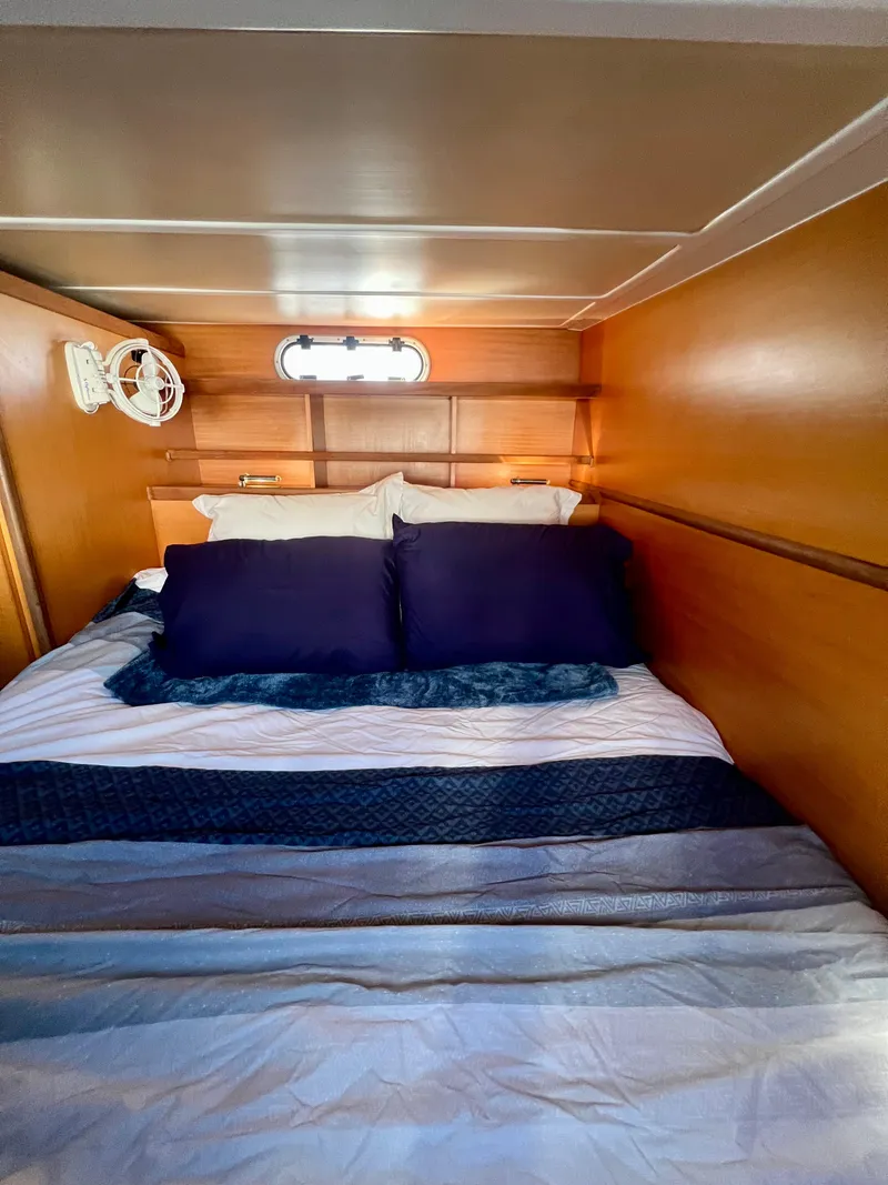 Slide: The Image of Cozy cabin bedroom in 2003 Catana 431 yacht with wooden walls and plush bedding. - 21