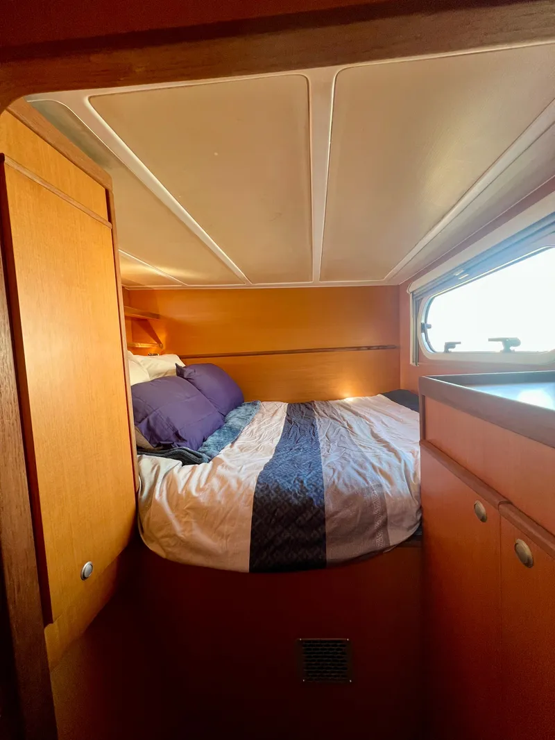 Slide: The Image of Cozy cabin interior of 2003 Catana 431 yacht with bed and window view. - 23