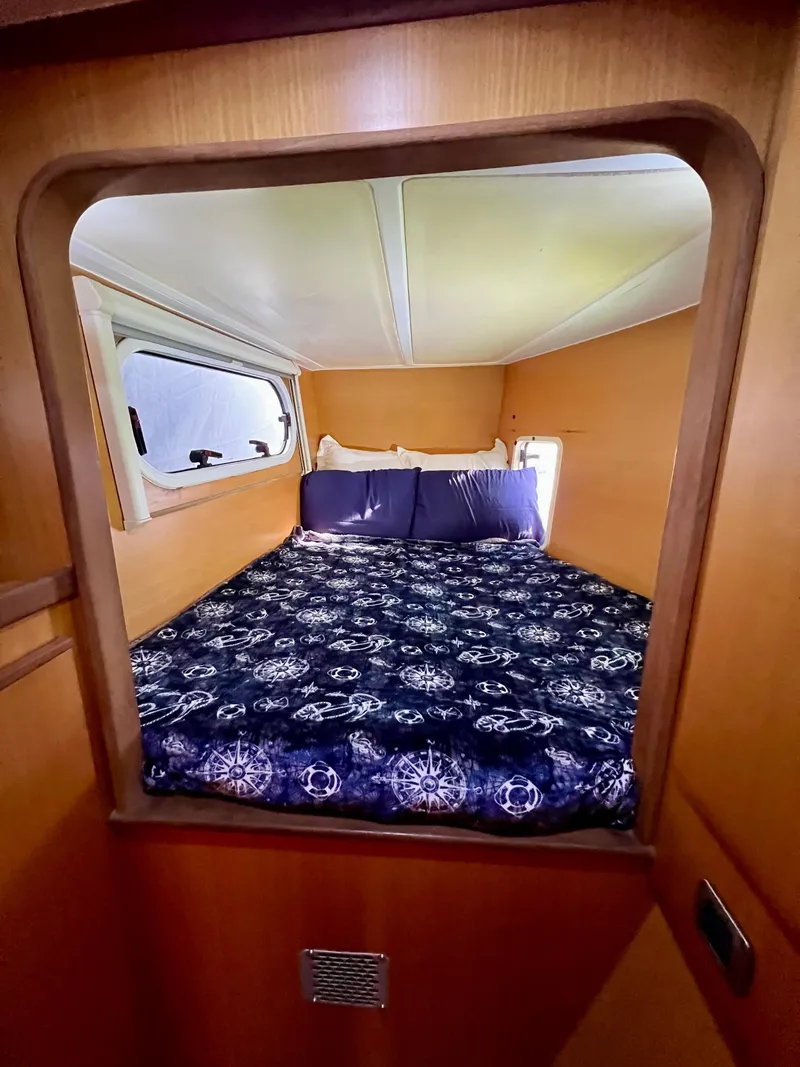 Slide: The Image of Cozy cabin interior of 2003 Catana 431 with nautical-themed bedding. - 24