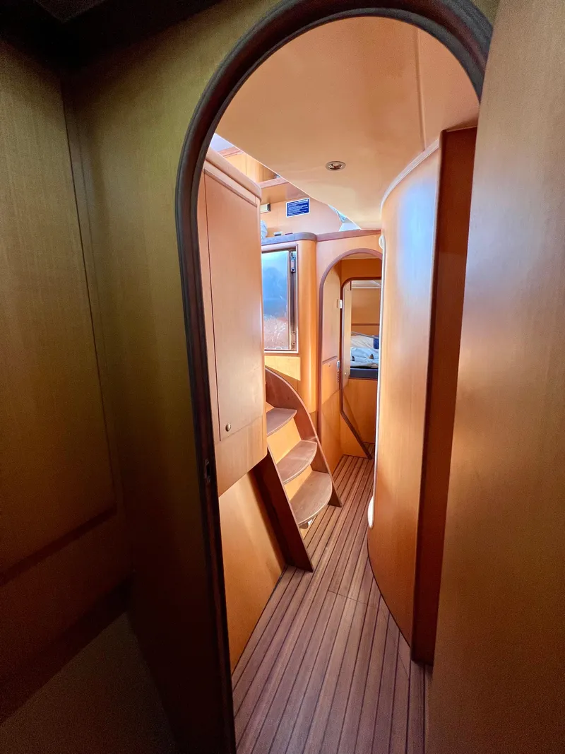 Slide: The Image of Interior of 2003 Catana 431 yacht, featuring wooden flooring and curved doorways. - 26