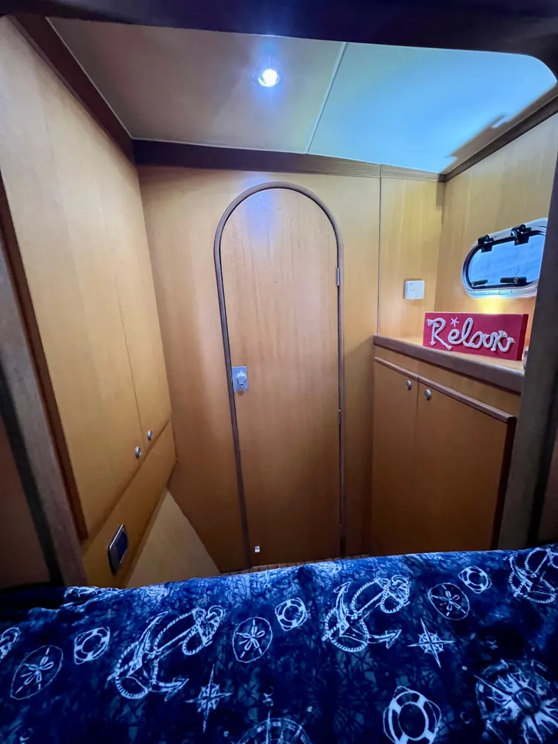 Slide: The Image of Interior of 2003 Catana 431 yacht cabin with wooden door and nautical decor. - 27