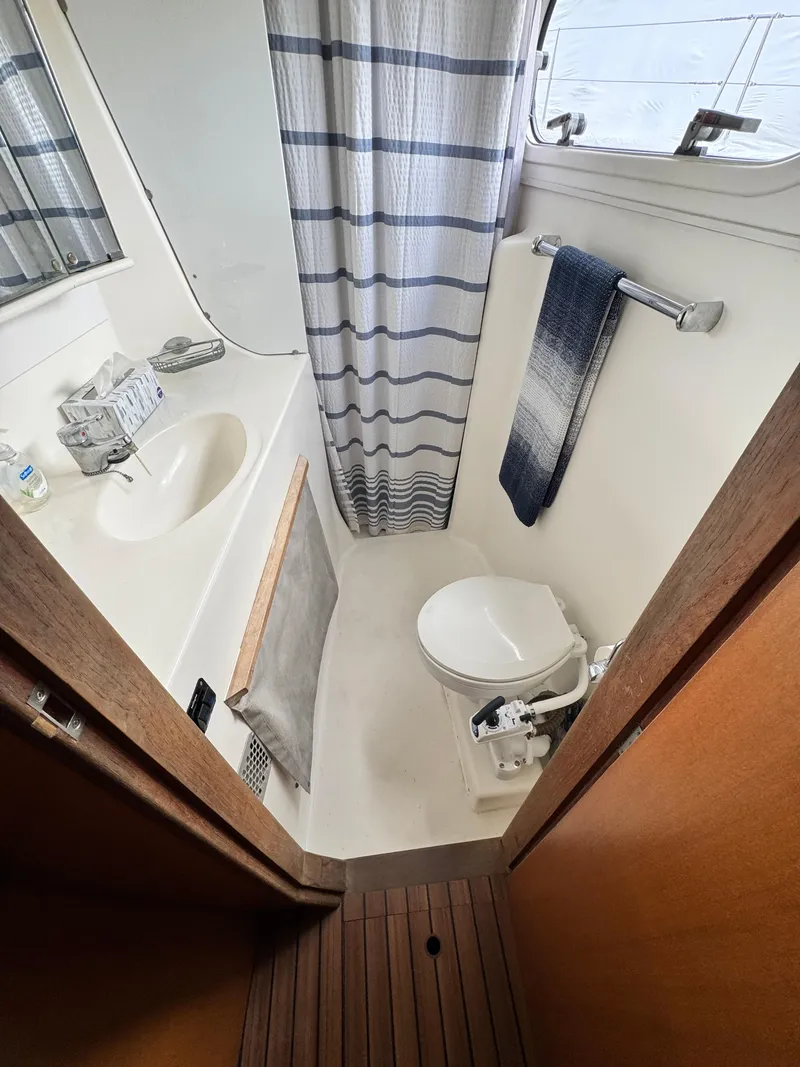Slide: The Image of Bathroom interior of 2003 Catana 431 yacht with shower, sink, and toilet. - 28