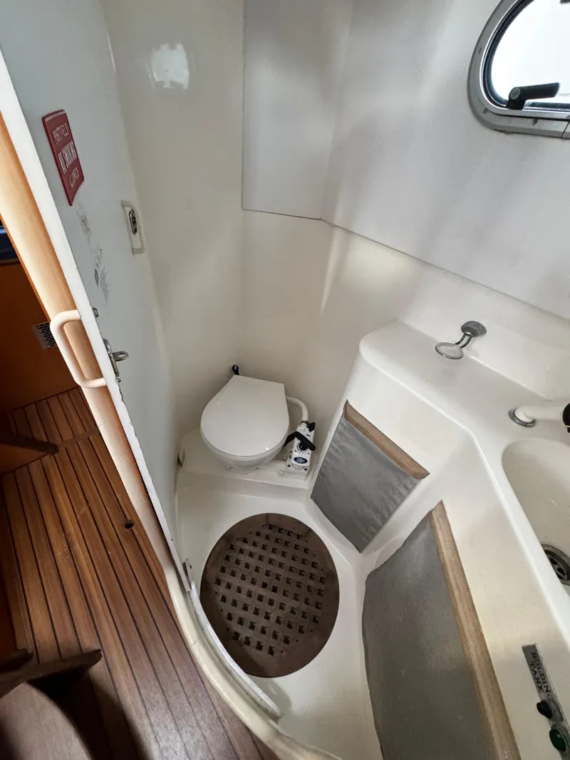 Slide: The Image of Catana 431 2003 yacht bathroom with toilet, sink, and wooden flooring. - 29