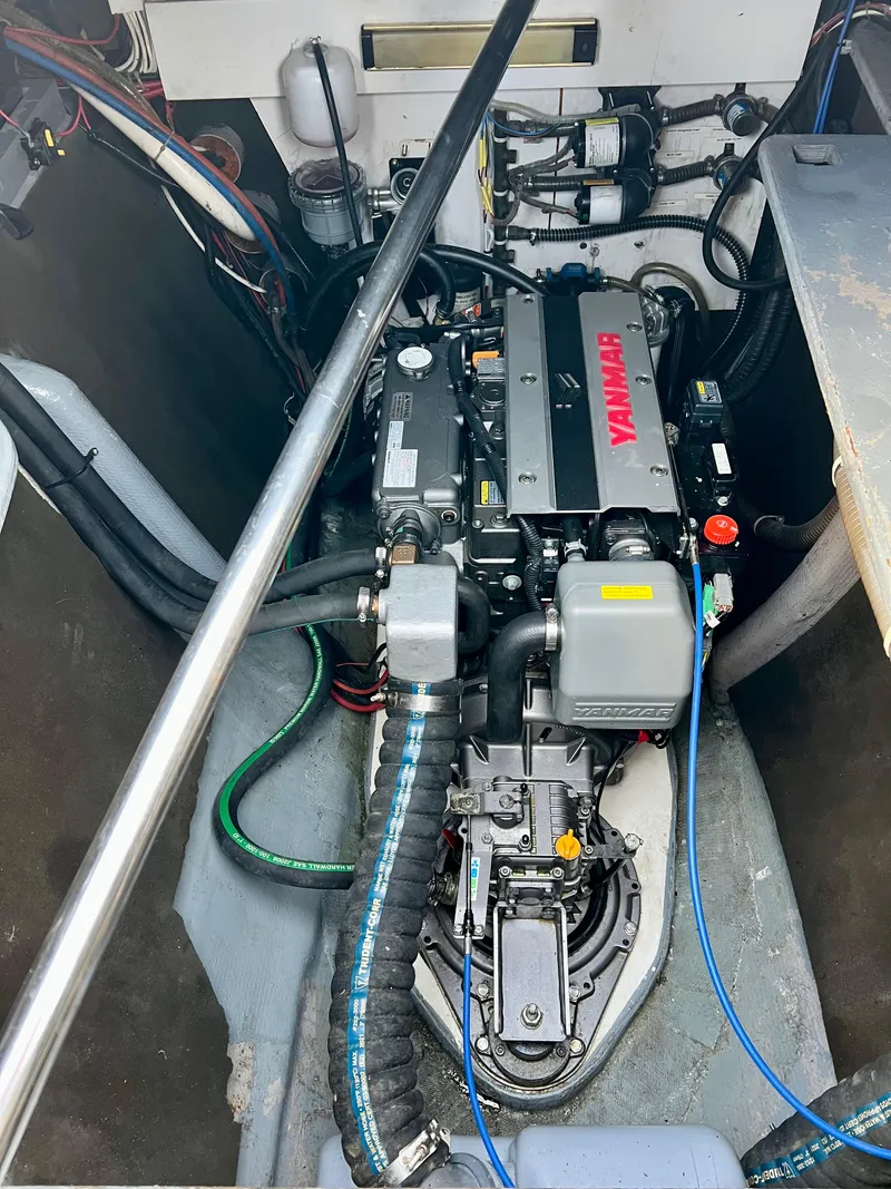 Slide: The Image of Engine compartment of a 2003 Catana 431 with Yanmar engine and various mechanical components. - 34