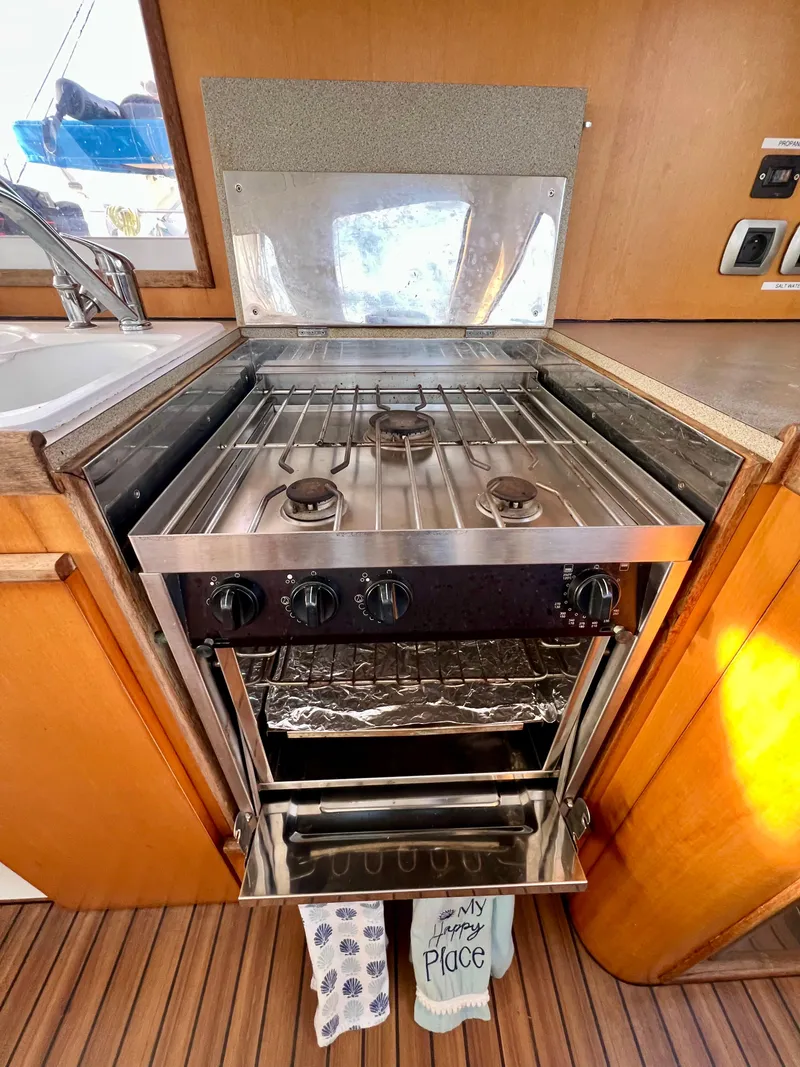 Slide: The Image of Galley kitchen in 2003 Catana 431 yacht with stainless steel stove and oven. - 37