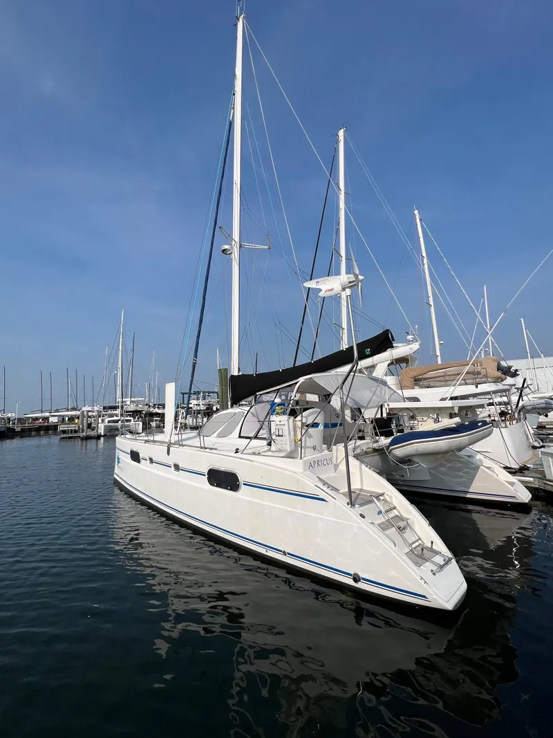 Slide: The Image of 2003 Catana 431 sailboat docked in marina under clear blue sky. - 4